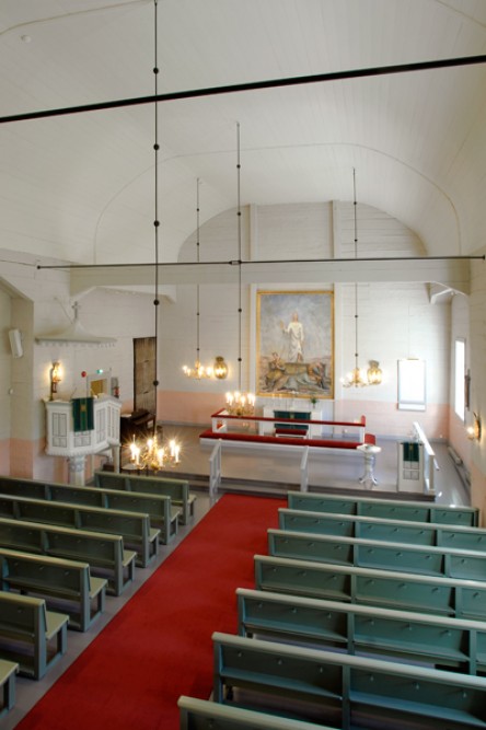 Utajärvi Church from the inside. Light interior, green benches.